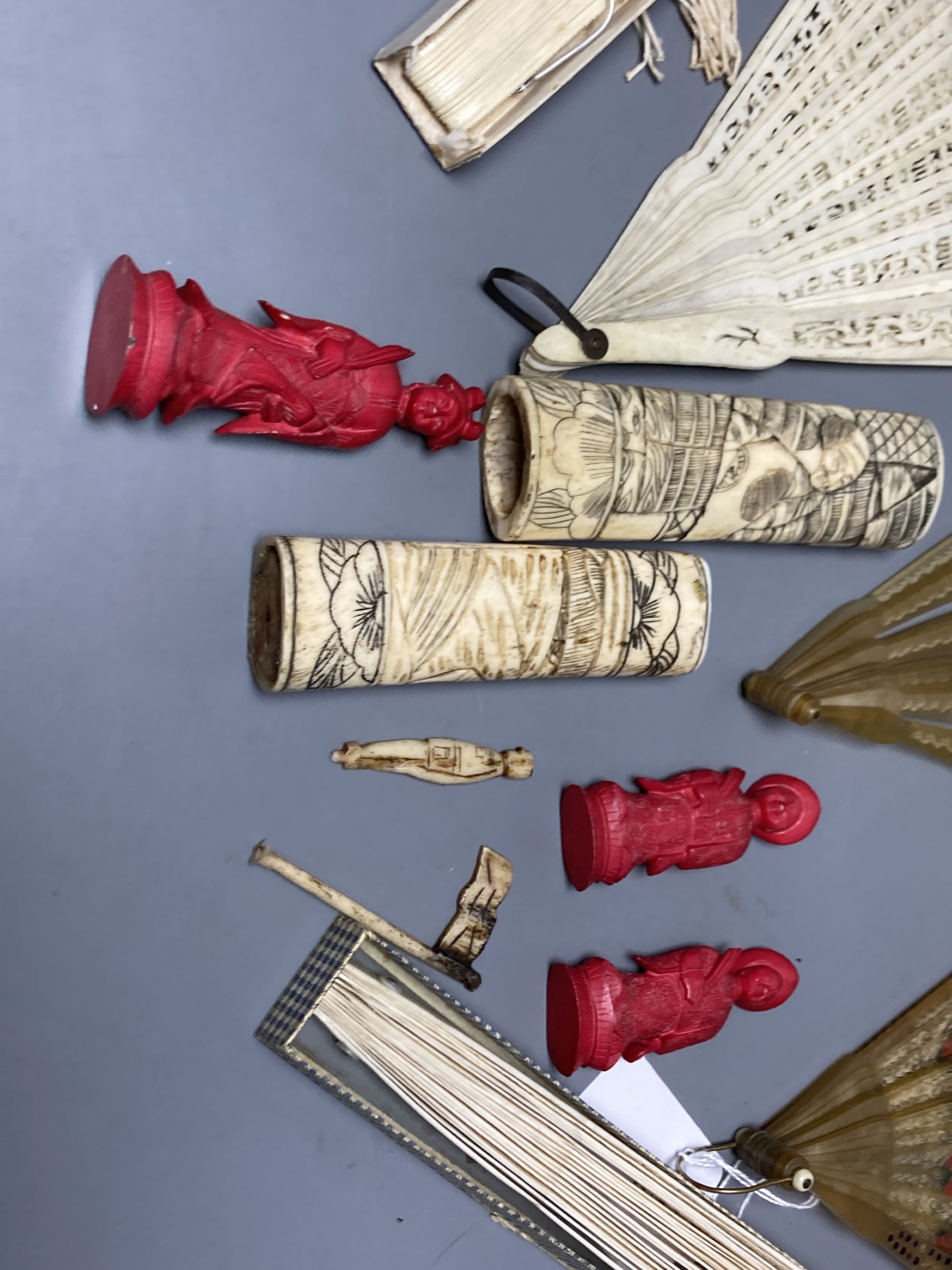 A quantity of bone and ivory carvings including fans and figures